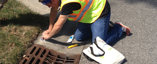 Indianapolis Team Member Cleaning Sewer Grate