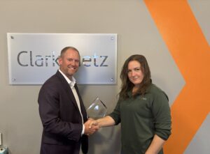 Keary receiving award with CEO Wes Christmas
