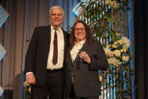 Chester Kochan, PE wins award for Mentor of the Year from ACEC IL. Photo is of Chester accepting the award.