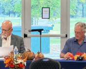 Sturgis Mayor Billy Adams and Councilman Hunter Adams seated at a meeting table reviewing documents.