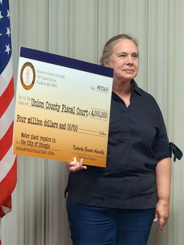 Kentucky Representative Suzanne Miles holds a ceremonial $4 million check for water plant improvements in Sturgis.
