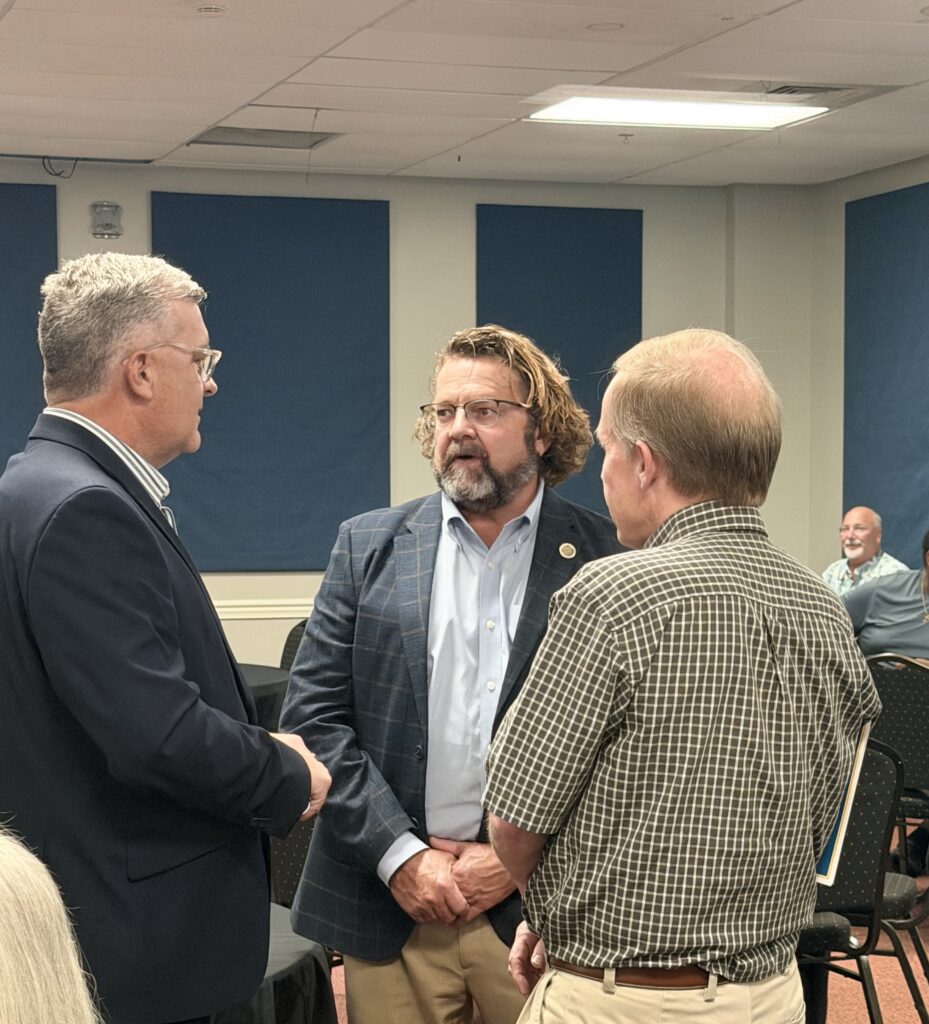 Union County Judge/Executive Adam O’Nan, center, speaks with Kentucky Senator Robby Mills, left, and another attendee.